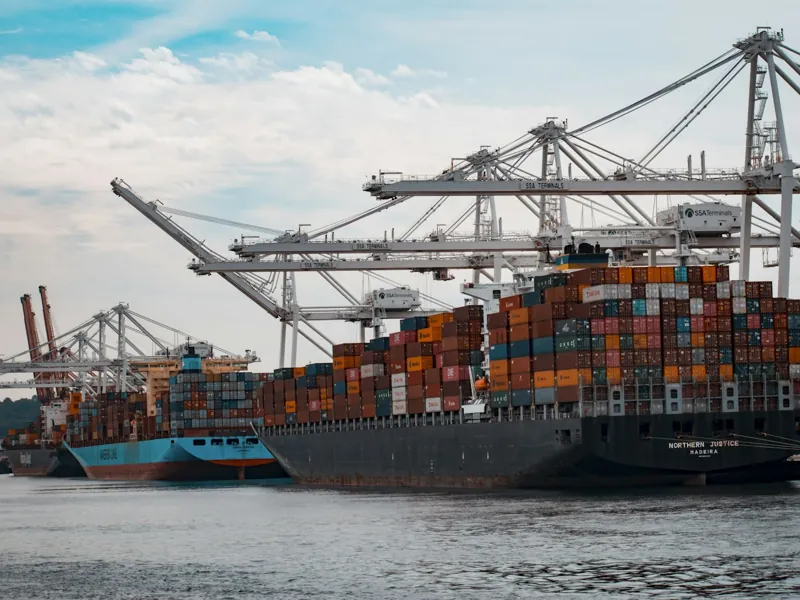 Container ships and cranes at an international cargo terminal.